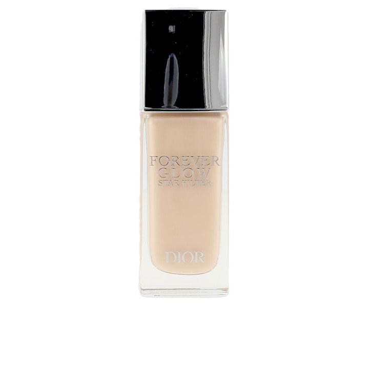 Pump bottle of lightweight luminous fluid, pale champagne shade, iris extract mention
