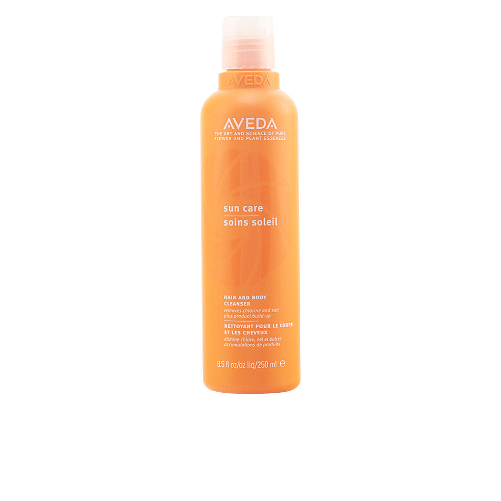 Aveda orange cylindrical plastic bottle with white text, matte finish and flip-top cap, cleans gently.