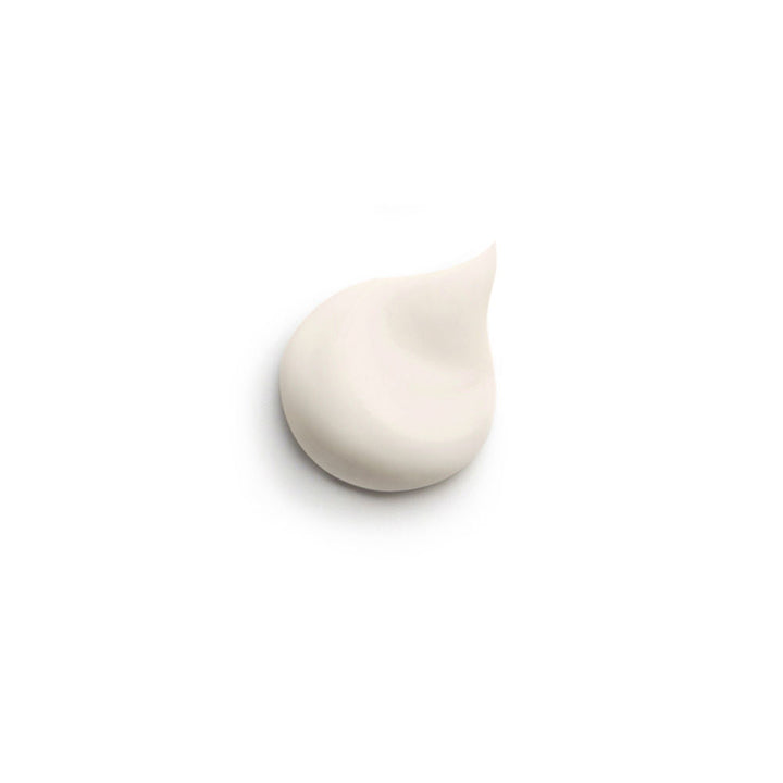 Sisley Frosted glass face cream jar with gold lid band beside square white and gold box, printed text visible