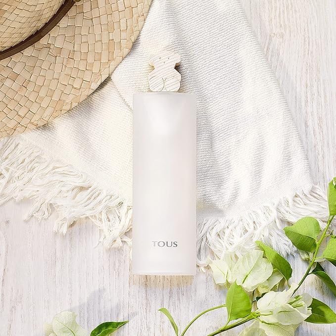Tous Light pink rectangular glass perfume bottle with bear-shaped cap, textured cardboard box, silver logo