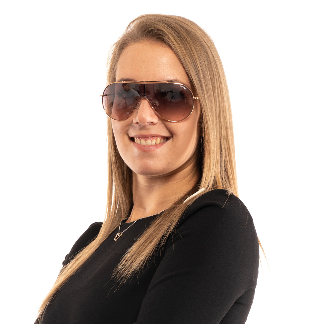 Rose gold aviator sunglasses with thin double-bridge frame and purple-to-grey gradient lenses on white background