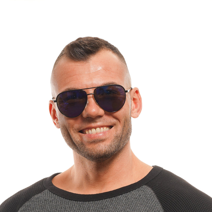 Unisex black thin metal aviator sunglasses with blue lenses and adjustable plastic nose pads on white background