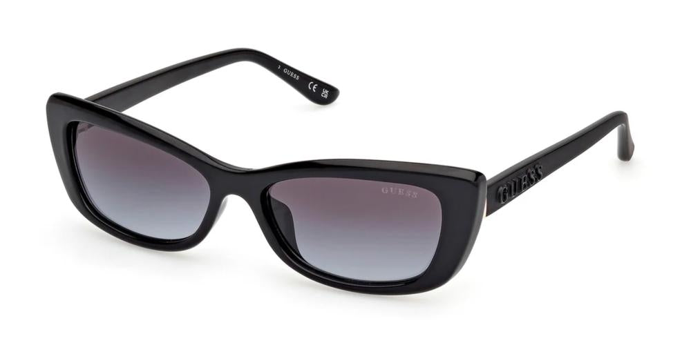 Black cat-eye sunglasses in glossy plastic with gradient lenses and Guess logo on temple and lens