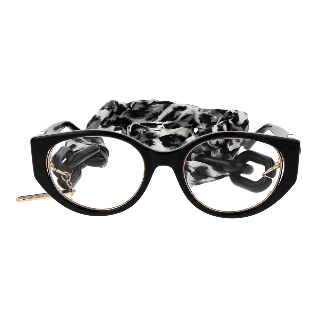 Black and gold cat-eye eyeglasses with thin metal temples and patterned fabric strap laid on white background