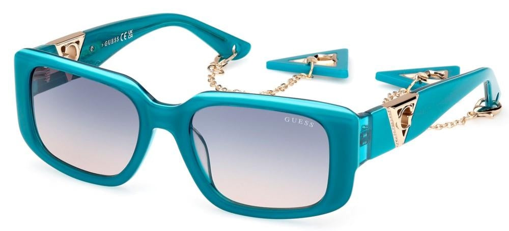 Teal rectangular sunglasses with gradient lenses, gold metal accents and dangling triangular charm chain on temples