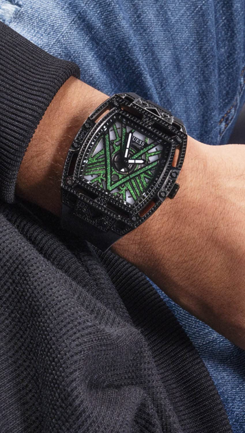 Unisex black watch with crystal-set case, geometric black dial and green accents, silicone strap