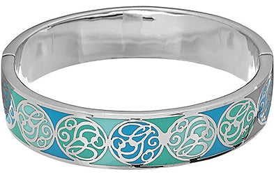 Silver bangle bracelet with glossy circular blue, green and black motifs beside a cardboard presentation box