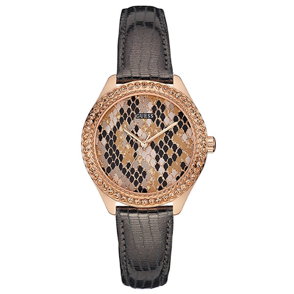 Guess rose gold wristwatch with leather strap, mineral dial and crystal bezel on beige surface