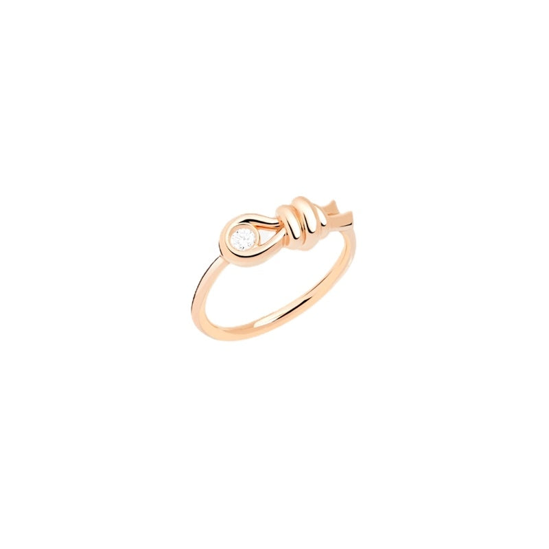Rose gold knot ring with single diamond set in decorative knot, polished finish