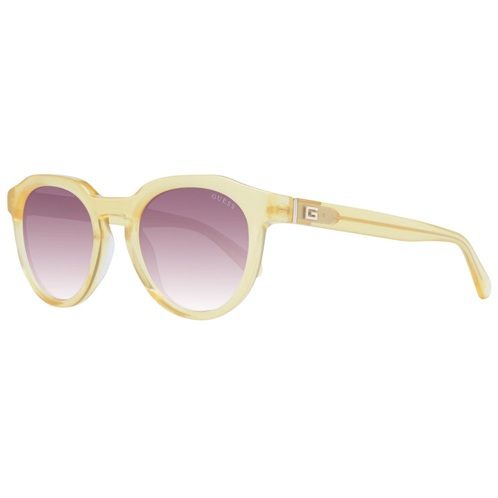 Yellow round sunglasses with purple gradient lenses and Guess logo on lens and temple
