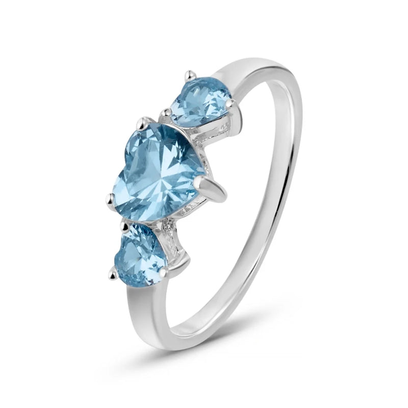 Polished silver ring with three light-blue heart gemstones set in prongs on a low-profile band